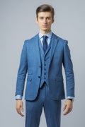 Man wearing a blue suit with a gray background