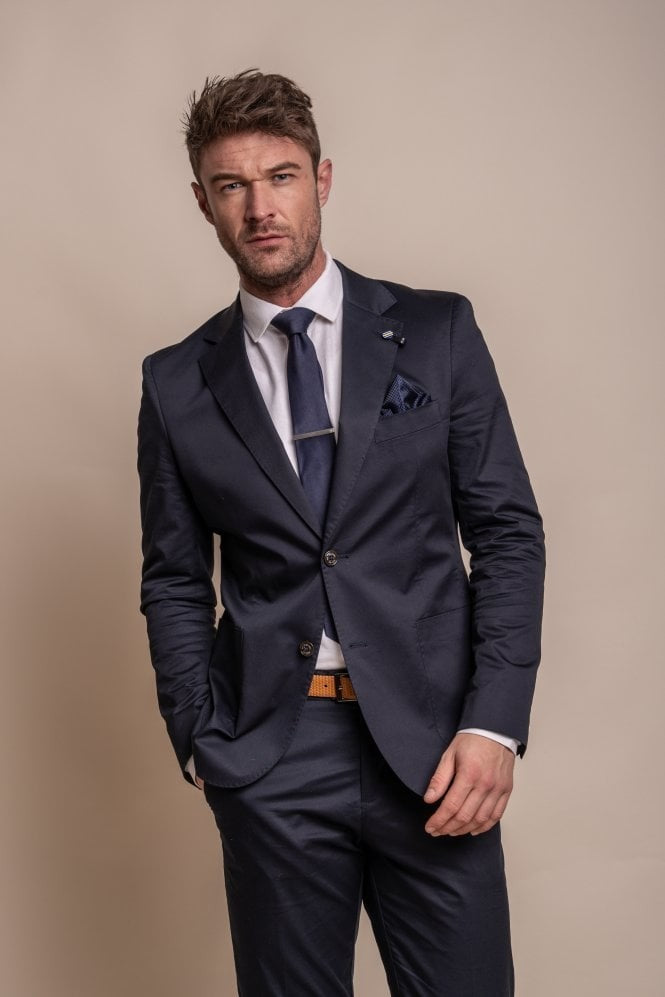 Man wearing a navy suit with a beige background
