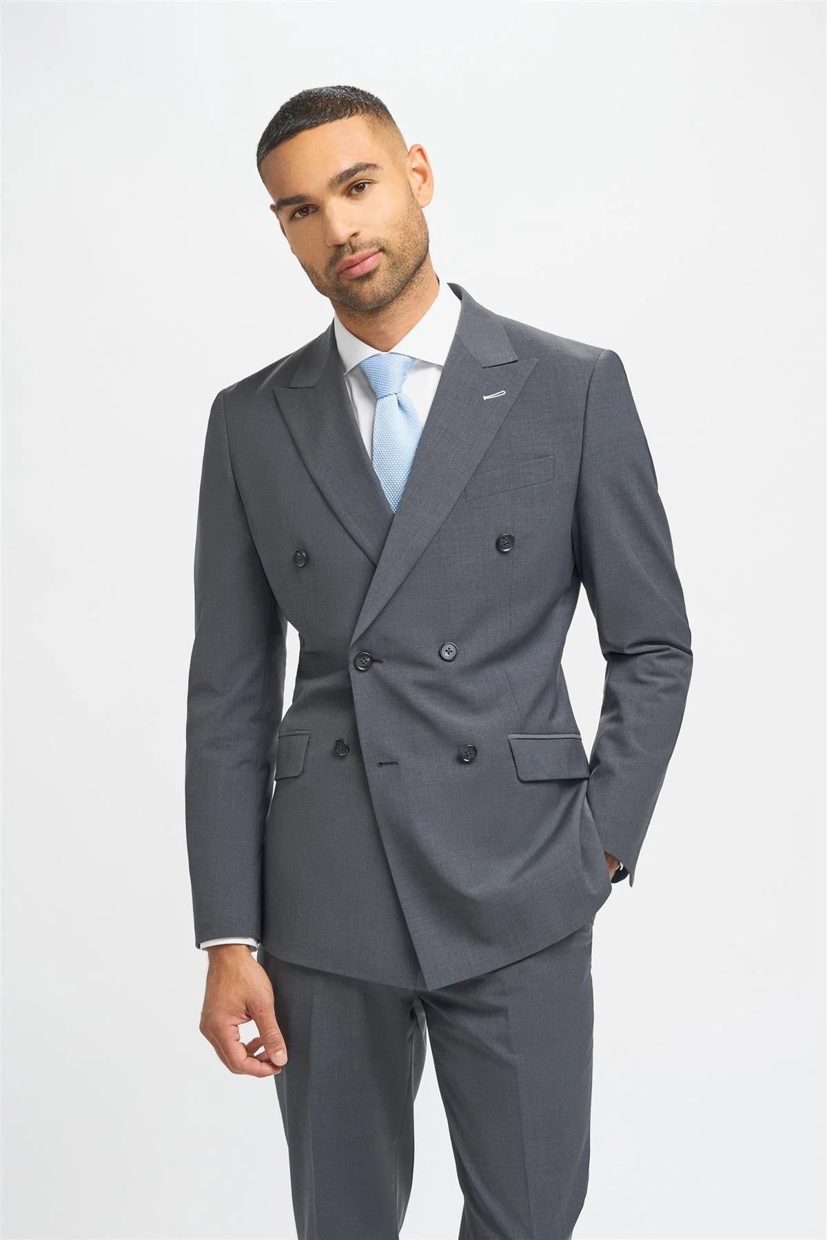Man wearing a gray suit with a light blue tie on a white background