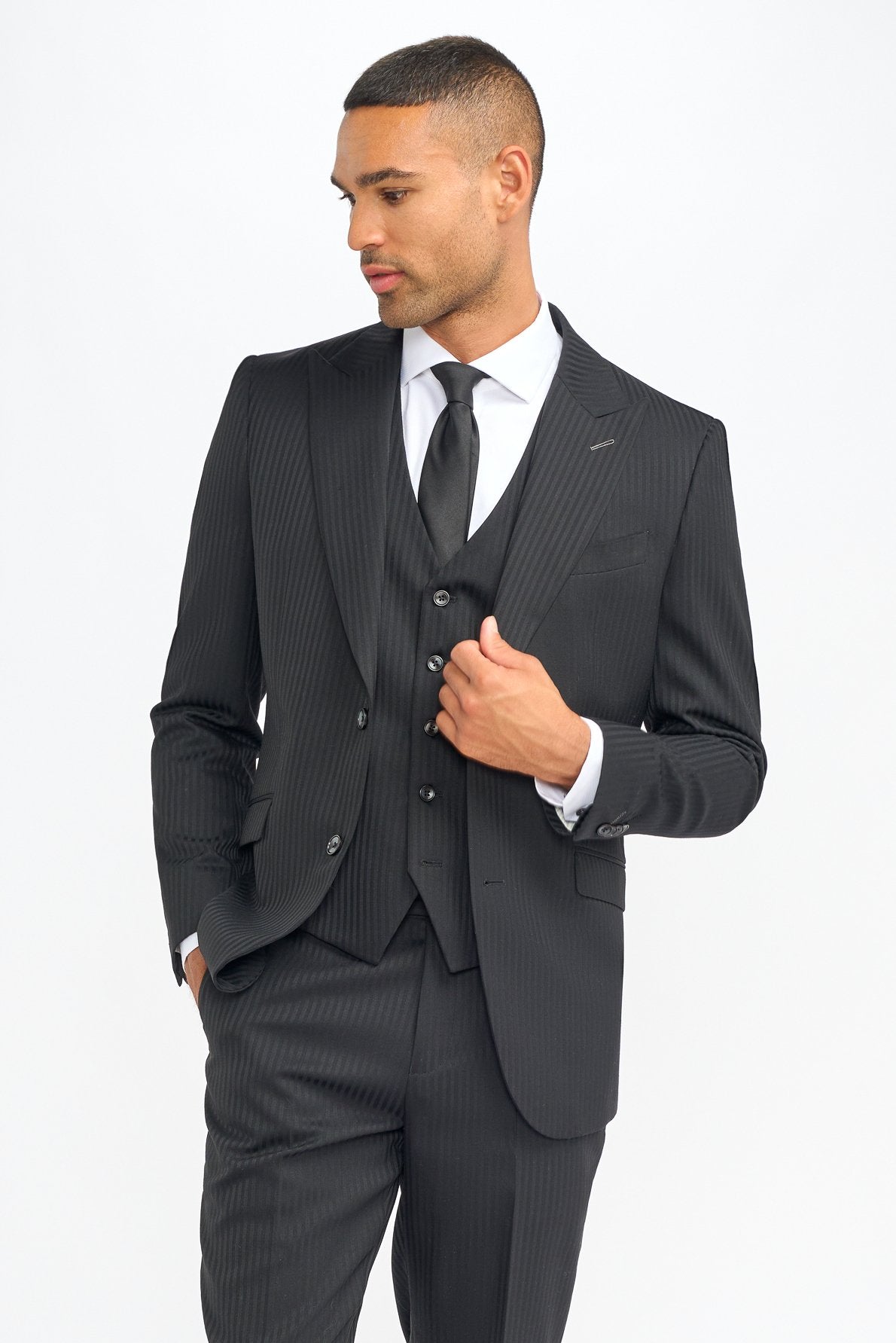 Man wearing a gray pinstripe suit with a white shirt and black tie on a white background