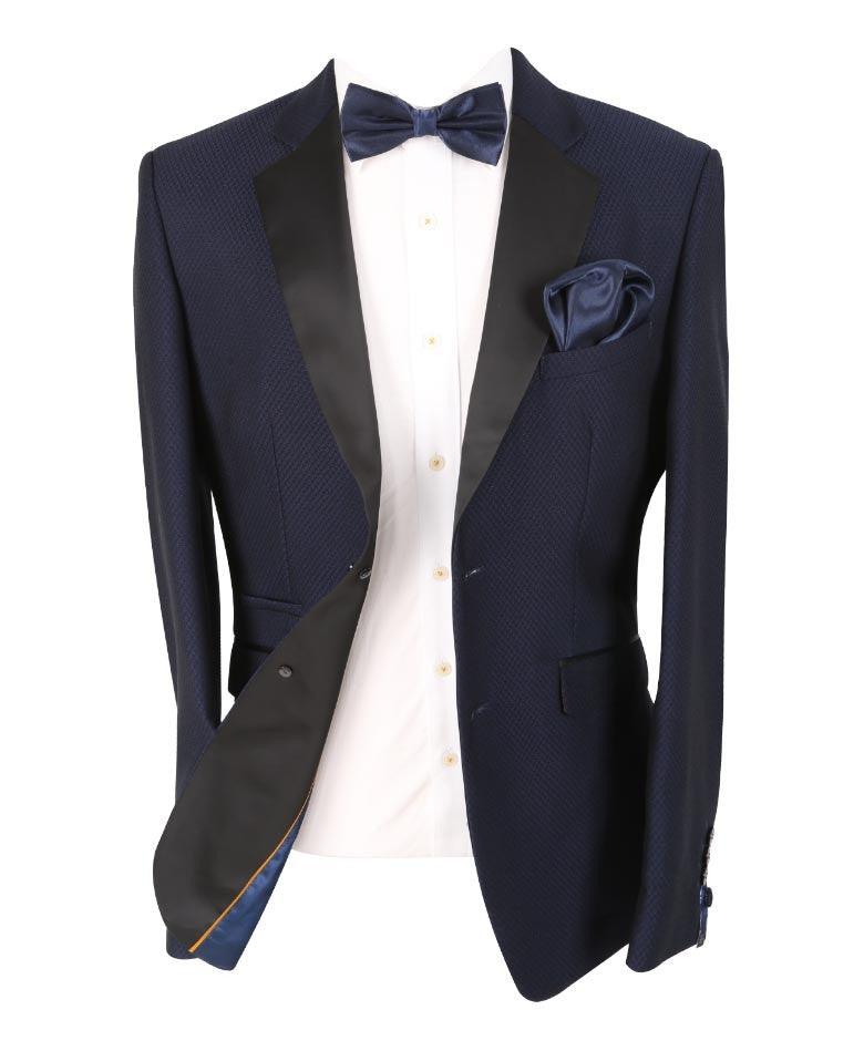 Navy tuxedo jacket with black lapels, white shirt, and bow tie on a white background