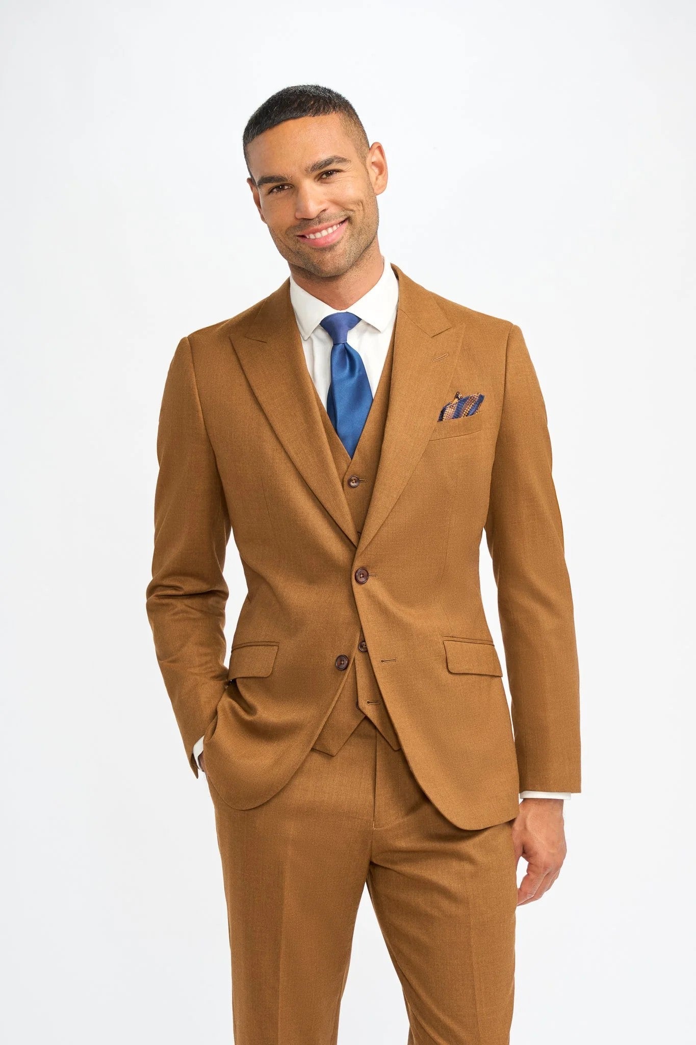 Man wearing a brown suit with a blue tie on a white background